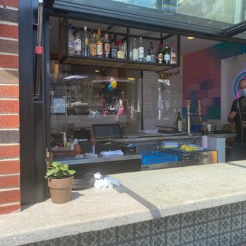 The Back End - a woman standing in front of a bar - Mexican Near Me - New Canaan, Connecticut