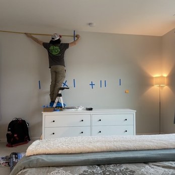 RDU TV Mounting & Audio Video - Nick hard at work, measuring the wall with precision. - Home Theatre Installation Near Me - Cary, North Carolina RDU TV Mounting & Audio Video - Nick hard at work, measuring the wall with precision. - Home Theatre Installation Near Me - Cary, North Carolina