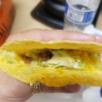 Del Taco - a person holding a taco in their hand - Tacos Near Me - Lacey, Washington Del Taco - a person holding a taco in their hand - Tacos Near Me - Lacey, Washington