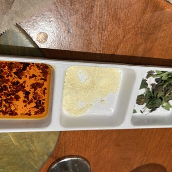 Urth Caffe - Side tray of toppings for pizza: chili oil, Parmesan cheese and fresh chopped herbs - Coffee & Tea Near Me - Laguna Beach, California Urth Caffe - Side tray of toppings for pizza: chili oil, Parmesan cheese and fresh chopped herbs - Coffee & Tea Near Me - Laguna Beach, California