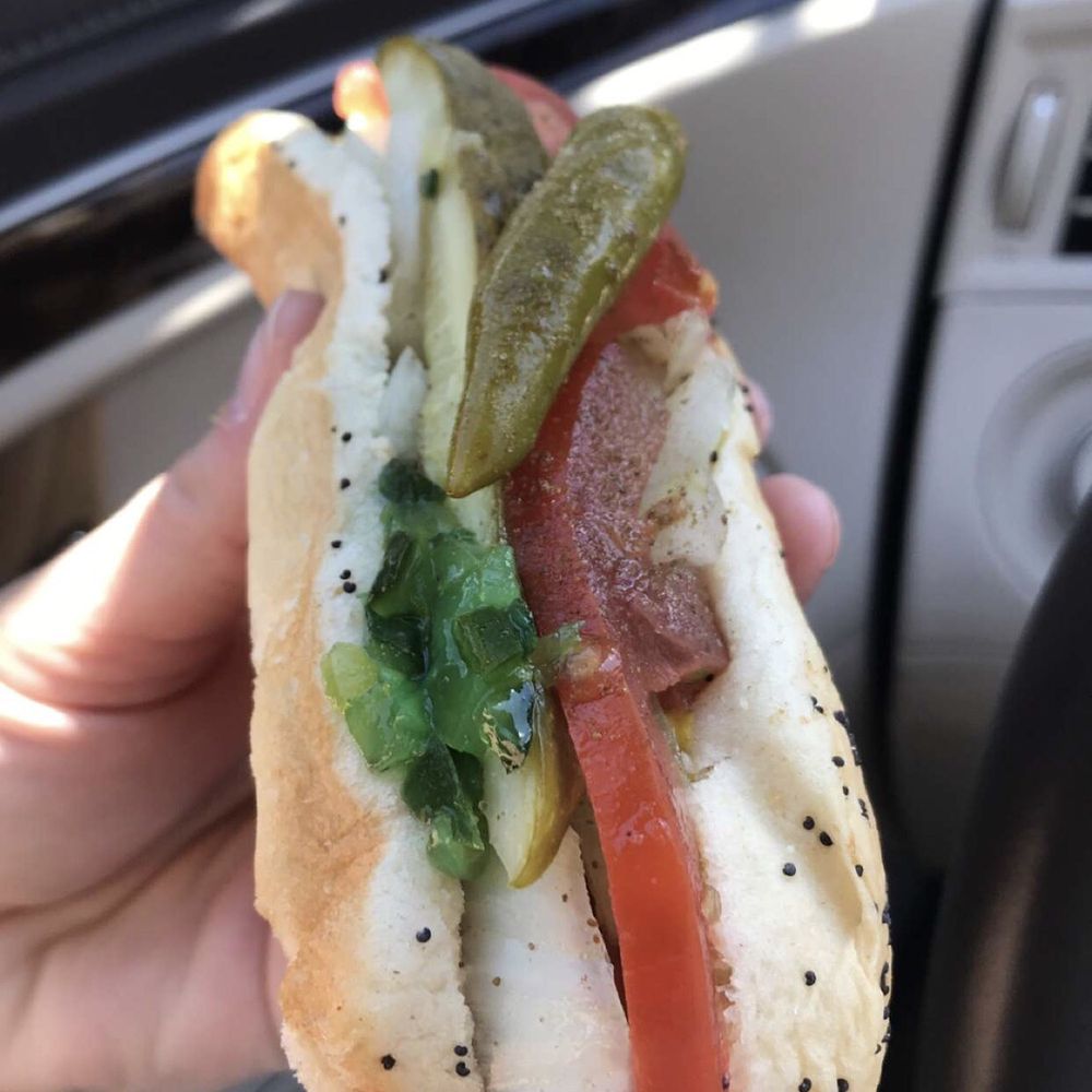 House of Dogs - a person holding a hot dog - Hot Dogs Near Me - Eagle River, Wisconsin House of Dogs - a person holding a hot dog - Hot Dogs Near Me - Eagle River, Wisconsin
