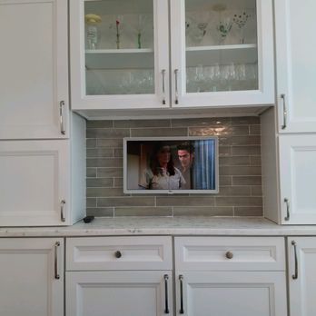 Hawthorne Integration Services - Small TV mounted on kitchen backsplash, cable box hidden behind - Home Theatre Installation Near Me