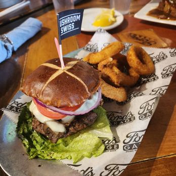Ford's Garage Dearborn - Mushroom Swiss burger with onion rings - Burgers Near Me - Dearborn, Michigan Ford's Garage Dearborn - Mushroom Swiss burger with onion rings - Burgers Near Me - Dearborn, Michigan