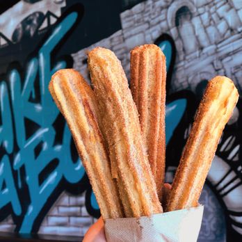 Pizza Patrón - a person holding a bag of churros - Pizza Near Me - South Houston, Texas Pizza Patrón - a person holding a bag of churros - Pizza Near Me - South Houston, Texas
