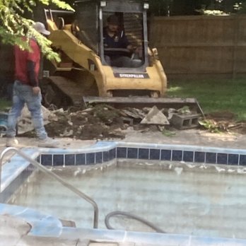 Dolphin Pool Services - Bobcat used to expedite the concrete removal. - Pool Cleaners Near Me - Springfield, Virginia