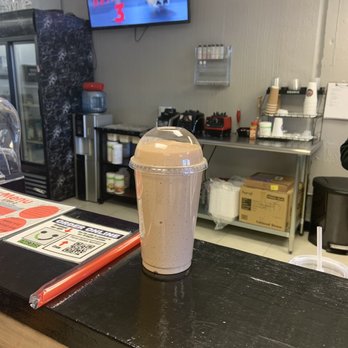 FIERCE GAINES NUTRITION - a smoothie in a plastic cup on a counter - Juice Bars & Smoothies Near Me - ARLINGTON, Texas FIERCE GAINES NUTRITION - a smoothie in a plastic cup on a counter - Juice Bars & Smoothies Near Me - ARLINGTON, Texas
