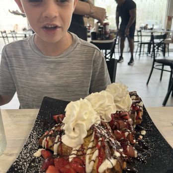 Eggtown - Stuffed strawberry French toast (plus he added chocolate syrup ) - Breakfast & Brunch Near Me - Riverview, Florida