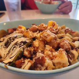 Poke bowl with brown rice, chicken tempura and chicken katsu, avocado, cucumber, mango, and delicious sauces. Poke bowl with brown rice, chicken tempura and chicken katsu, avocado, cucumber, mango, and delicious sauces.