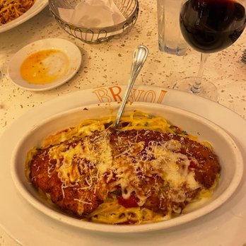 Bravo! Italian Kitchen - a plate of pasta and a glass of wine - Italian Near Me - West Des Moines, Iowa Bravo! Italian Kitchen - a plate of pasta and a glass of wine - Italian Near Me - West Des Moines, Iowa