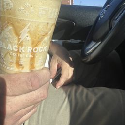 a hand holding a cup of coffee a hand holding a cup of coffee