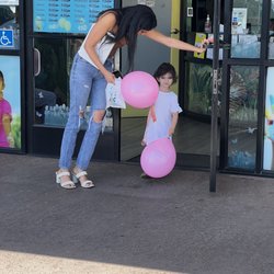ABC Kids Dental Group - Ella's little sister walking out of the clinic with a pink ballon.