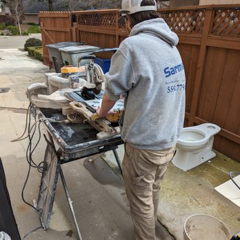 Sarment Tile - a man working on a table - General Contractors Near Me Sarment Tile - a man working on a table - General Contractors Near Me