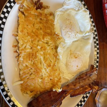 Cafe South - Two over easy eggs with homefries, bacon, and a side of whole wheat buttered toast (not pictured) - Breakfast & Brunch Near Me - Charlotte, North Carolina