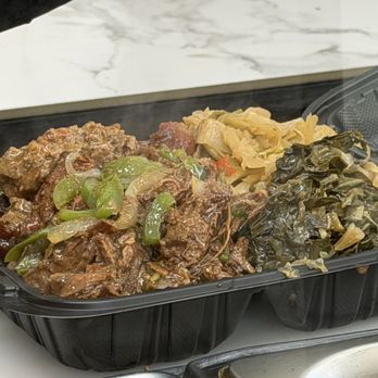 Comfort And Crave - Mississippi pot roast and meatloaf over yellow rice with collard greens and cabbage - Soul Food Near Me - Altamonte Springs, Florida