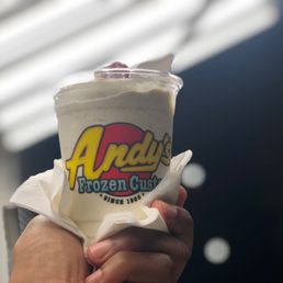 a hand holding a cup of ice cream a hand holding a cup of ice cream