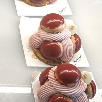 Parfait Paris - a row of pastries with pink frosting - Bakeries Near Me - Coronado, California Parfait Paris - a row of pastries with pink frosting - Bakeries Near Me - Coronado, California