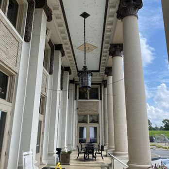 The Hotel Bentley - Front porch columns and rocking chairs. - Hotels Near Me - Alexandria, Louisiana The Hotel Bentley - Front porch columns and rocking chairs. - Hotels Near Me - Alexandria, Louisiana