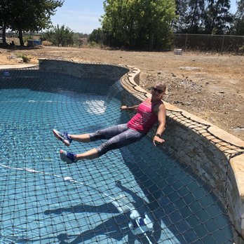 Baby Proof Pool Safety Systems - Me sitting on the pool safety net. - Childproofing Near Me Baby Proof Pool Safety Systems - Me sitting on the pool safety net. - Childproofing Near Me