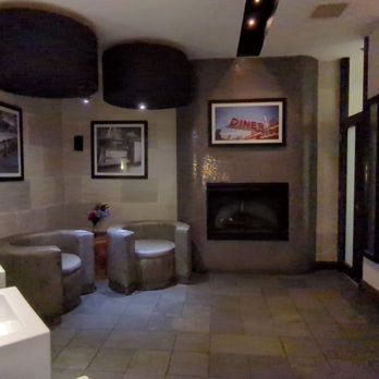 Bar One - More plush than hotel bathroom fireplace and 2 lounge chairs! - American Near Me - Vancouver, British Columbia