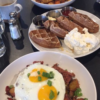 Bruncheonette - Loaded scramble on top, the waffle and then at the bottom the corned beef hash with sunny side up eggs. - Breakfast & Brunch Near Me - Spokane, Washington Bruncheonette - Loaded scramble on top, the waffle and then at the bottom the corned beef hash with sunny side up eggs. - Breakfast & Brunch Near Me - Spokane, Washington