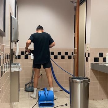 Phoenix Tile And Grout Cleaning - a man with a blue hose - Grout Services Near Me - Phoenix, Arizona Phoenix Tile And Grout Cleaning - a man with a blue hose - Grout Services Near Me - Phoenix, Arizona