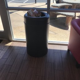 a trash can in front of a window a trash can in front of a window