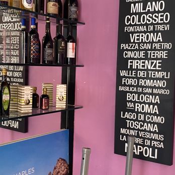 Amore Caffe - a shelf of wine bottles and a menu - Sandwiches Near Me - Boca Raton, Florida