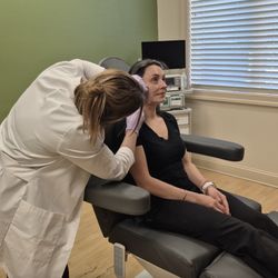 Joanne Lopes, MD - Cosmetic Surgery Center - In this image, Nurse Practitioner Krystina at Cosmetic Surgery Center is expertly administering Botox injections to a patient's jawline.