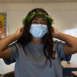 Holy Family Catholic Academy - HFCA middle school student proudly wearing the haku lei she handmade for May Day.
