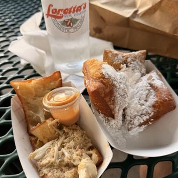 Loretta's Authentic Pralines - Crab beignet (left) and praline beignets (right) - Candy Stores Near Me - New Orleans, Louisiana Loretta's Authentic Pralines - Crab beignet (left) and praline beignets (right) - Candy Stores Near Me - New Orleans, Louisiana
