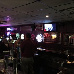 people at the bar watching televisions