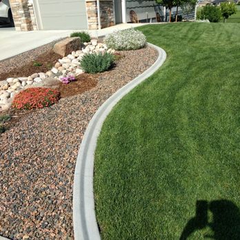 Krafts Kurbing - a man taking a picture of his front yard - Landscaping Near Me