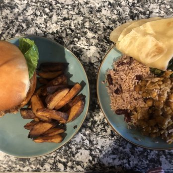 Irie Kitchen - Left Pic : Irie Chicken Sandwhich. Right Pic : Garbanzo Curry with a side of rice, greens and roti. - Caribbean Near Me - Grand Rapids, Michigan Irie Kitchen - Left Pic : Irie Chicken Sandwhich. Right Pic : Garbanzo Curry with a side of rice, greens and roti. - Caribbean Near Me - Grand Rapids, Michigan