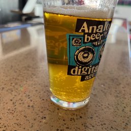 a glass of beer on a counter