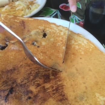 Addi's Diner - Digging blueberry from the corner of a pancake. - American Near Me - Springfield, Oregon Addi's Diner - Digging blueberry from the corner of a pancake. - American Near Me - Springfield, Oregon