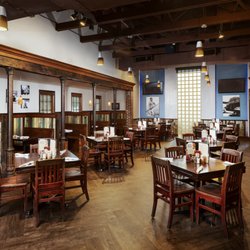 Don’s Seafood - Gonzales - The main dining room at our Gonzales location, with soaring ceilings, brick-lined columns, and blue accent walls hung with hi...