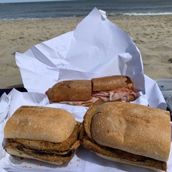 Pazzo Italiano - two sub sandwiches on a table on the beach - Delis Near Me - Rehoboth Beach, Delaware Pazzo Italiano - two sub sandwiches on a table on the beach - Delis Near Me - Rehoboth Beach, Delaware