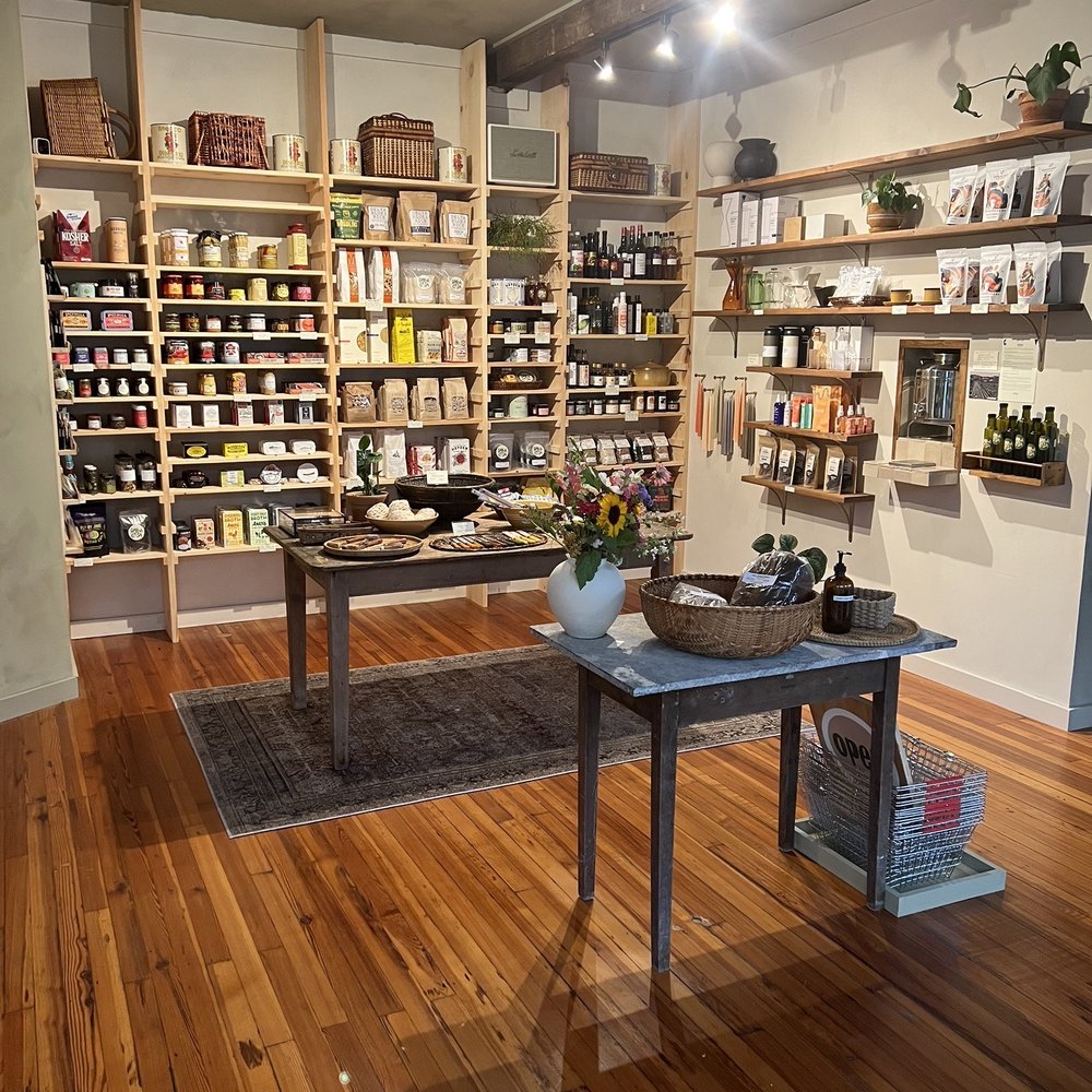 Paracasa - a room with a table and shelves of books - Grocery Near Me - Hensonville, New York Paracasa - a room with a table and shelves of books - Grocery Near Me - Hensonville, New York