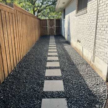 AKM Turf and Greens - Side yard black tejas basalt gravel with 18"x18" concrete pavers installed - Artificial Turf Near Me - Frisco, Texas AKM Turf and Greens - Side yard black tejas basalt gravel with 18"x18" concrete pavers installed - Artificial Turf Near Me - Frisco, Texas
