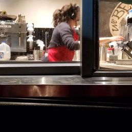 a woman working in a coffee shop a woman working in a coffee shop