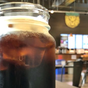 Lion Cafe and General Store - Cold brew with the symbolic lion logo in the background. - Coffee & Tea Near Me - Honolulu, Hawaii Lion Cafe and General Store - Cold brew with the symbolic lion logo in the background. - Coffee & Tea Near Me - Honolulu, Hawaii