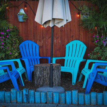 Sunset Bowls - a patio with blue chairs and an umbrella - Food Trucks Near Me - Fort Walton Beach, Florida Sunset Bowls - a patio with blue chairs and an umbrella - Food Trucks Near Me - Fort Walton Beach, Florida