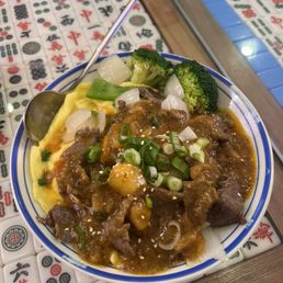 Satay beef over eggs and rice