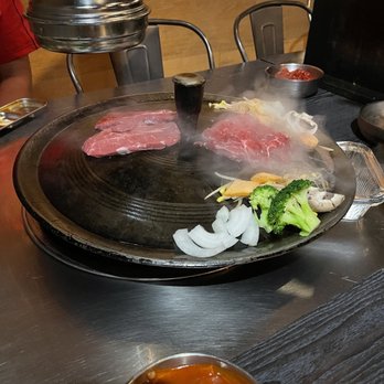 Let's Meat - Steak and vegetables being cooked on hot stone - Korean Near Me - New York, New York