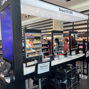 SEPHORA - Book your beauty treatment appointments on line. - A beauty station with digital screens and a reserved sign is set up in a cosmetics store, with customers and staff engaging in beauty services. - Cosmetics & Beauty Supply Near Me - Pasadena, California