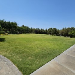 Huge grass area and restrooms in the distance.