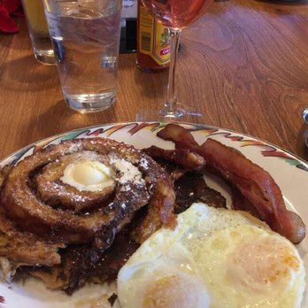 Brookfields Restaurant - Cinnamon Swirl French Toast with a side of over medium eggs, bacon, and sausage - American Near Me - Roseville, California