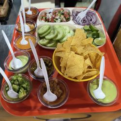 Asadero los Molcajetes - Salsa Tray with cucumber and chips . Super delicious