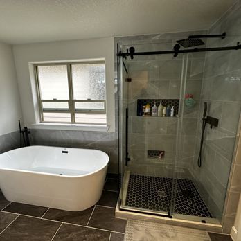 JNP Style - a bathtub and shower in a bathroom - General Contractors Near Me JNP Style - a bathtub and shower in a bathroom - General Contractors Near Me