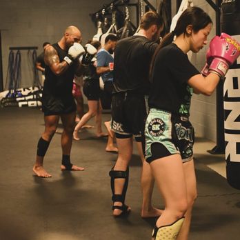Song Khao - The other end of our heavy bag rack featuring some more students hard at work. - Muay Thai Near Me - Stoughton, Massachusetts Song Khao - The other end of our heavy bag rack featuring some more students hard at work. - Muay Thai Near Me - Stoughton, Massachusetts